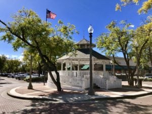 White gazebo with American flag in background in downtown Upland, CA