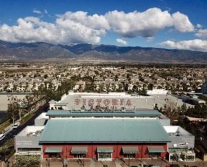 Aerial view of Victoria Gardens sign in Rancho Cucamonga, CA with San Gabriel mountains in the background