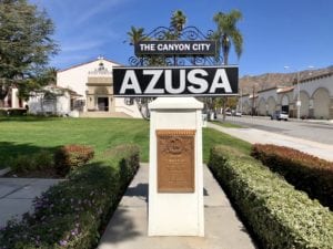 Large fountain with Azusa Auditorium in the background framed by two palm trees