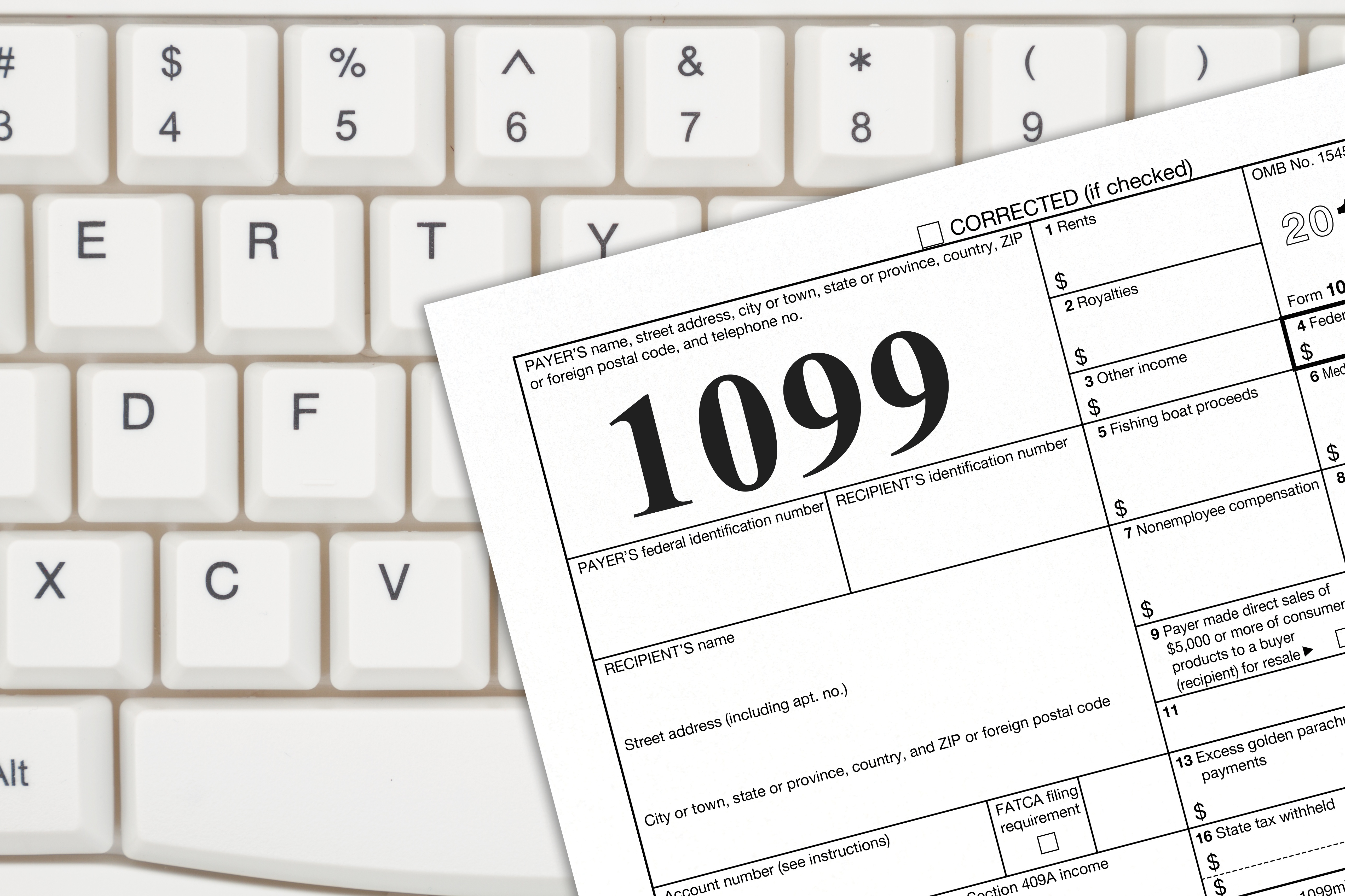 1099 tax form on top of white keyboard