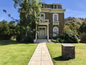 Front facing view of haunted and spooky looking old mansion that is Phillips Mansion in Pomona, CA